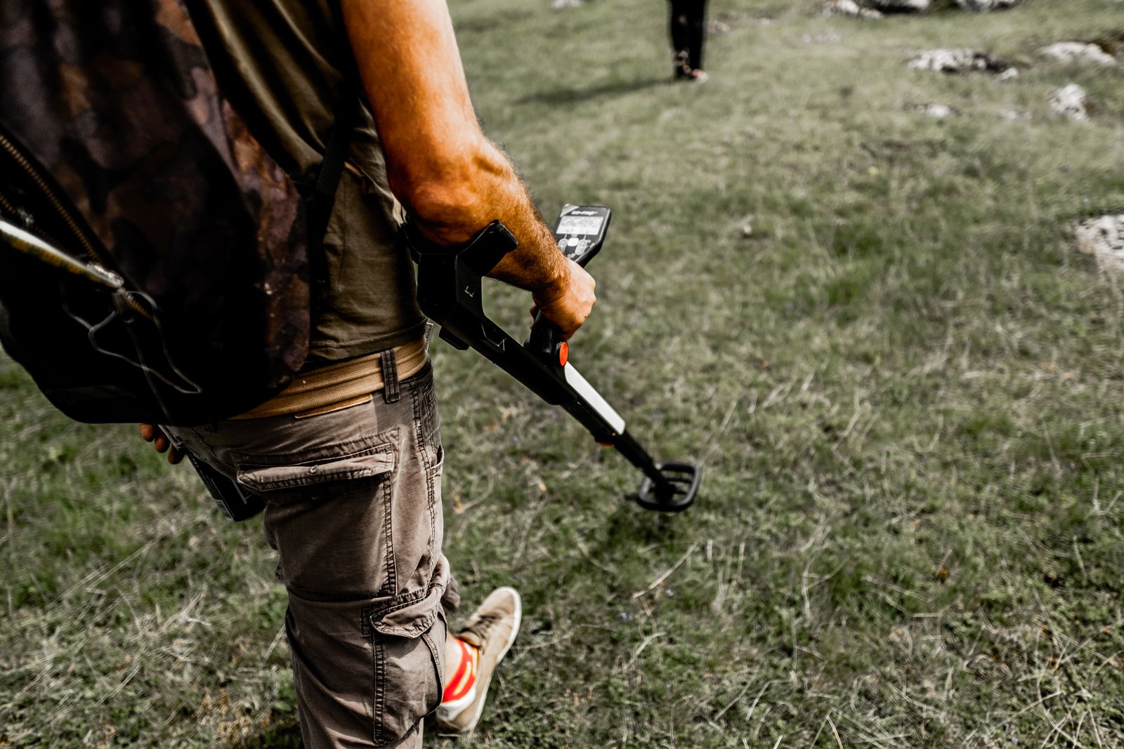 Prospector using detection equipment to locate viable ground
